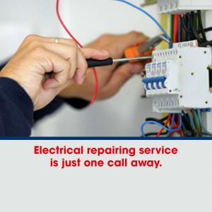 Electrician working on electrical panel with tools