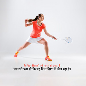 A female badminton player mid-swing, ready to hit the shuttlecock.