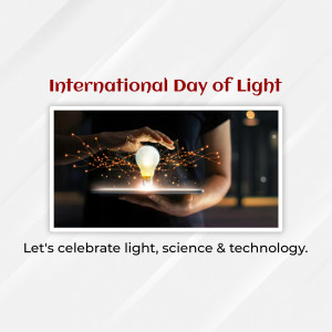 Image depicting a hand holding a glowing lightbulb above a tablet, symbolizing innovation and the International Day of Light.