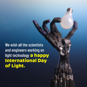 A robotic hand holding a light bulb, celebrating the International Day of Light.