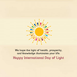 Illustration of a sun with colorful rays and text wishing a Happy International Day of Light.
