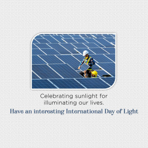 Two workers installing solar panels on a rooftop, celebrating the International Day of Light.