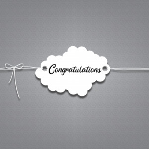 A white tag with the word 'Congratulations' written on it, tied with a string.