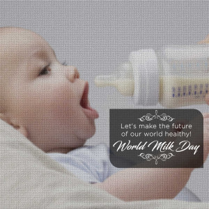 A baby reaching for a bottle of milk with a World Milk Day message.