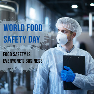 A worker in a food processing facility wearing protective gear and holding a clipboard.