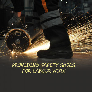Close-up of worker's safety boots during metal grinding