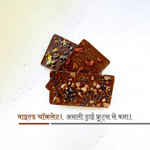 Close-up of three dark chocolate bars topped with various dried fruits and nuts.