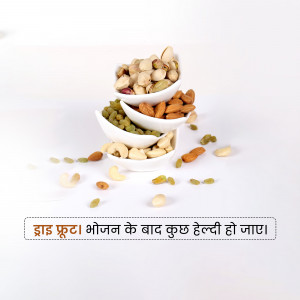 A stack of white bowls filled with various dry fruits like almonds, pistachios, cashews, and raisins.