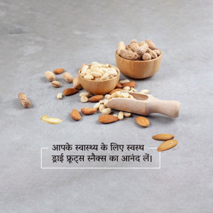 A variety of dry fruits including almonds, cashews, and pistachios in wooden bowls and scattered on a grey surface.