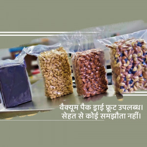 Four vacuum-sealed packs of different dry fruits displayed on a metal surface.