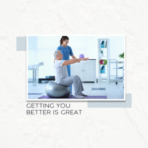 A physical therapist assisting a senior man with exercise using a stability ball.