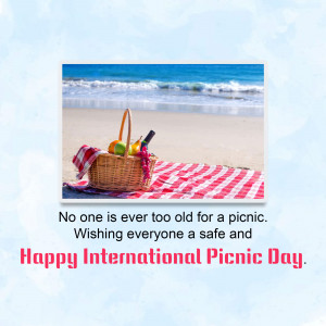 Picnic basket on a beach with a message wishing everyone a Happy International Picnic Day.