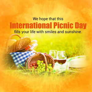 Picnic basket with food and wine on a blanket with text 'International Picnic Day'