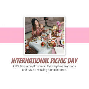 A woman enjoying an indoor picnic with food and drinks on a blanket.