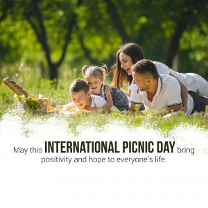Family enjoying a picnic in a green field on International Picnic Day