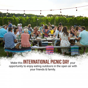 People enjoying a picnic outdoors with string lights and a long table