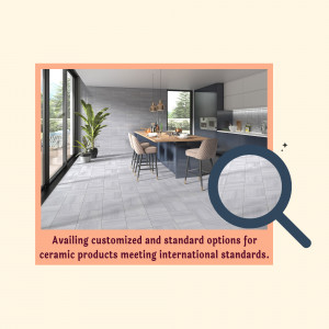 Interior view of a modern kitchen with grey ceramic tiles and a dining area.