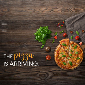 Overhead view of a pizza with fresh ingredients on a rustic wooden table.