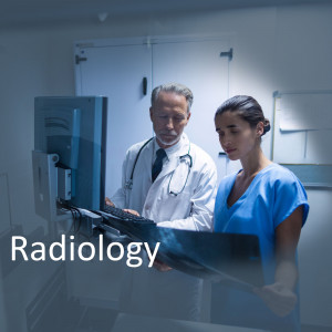 Doctor and nurse looking at a medical scan on a computer in a radiology department.