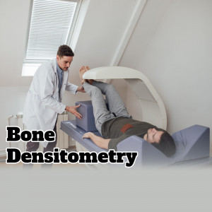 A doctor performing a bone densitometry scan on a patient.
