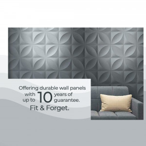 Close-up of gray 3D textured wall panels with a sofa in the background
