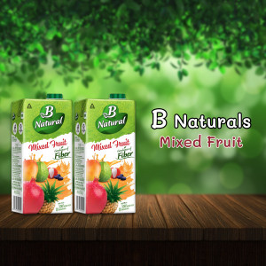 Two cartons of B Naturals Mixed Fruit juice with fruits in the background