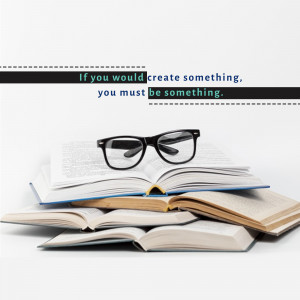 Stack of books with glasses and motivational quote