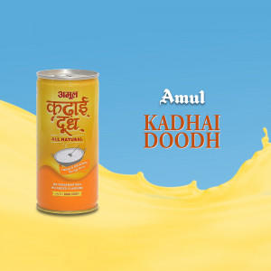 A can of Amul Kadhai Doodh with a splash of yellow liquid.