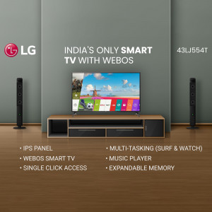 LG Smart TV with WebOS displayed on a wooden console with speakers