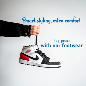 Close-up of a person holding a stylish white, red, and black sneaker.