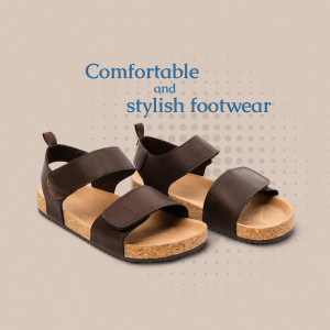 Pair of brown leather sandals with velcro straps on a beige background
