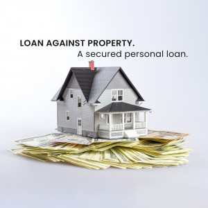 Miniature house on top of stacks of money representing a loan against property