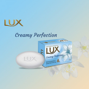 Lux Creamy Perfection soap bar with packaging and floral accents