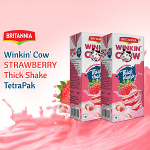 Two TetraPak cartons of Britannia Winkin' Cow Strawberry Thick Shake with strawberry splash.