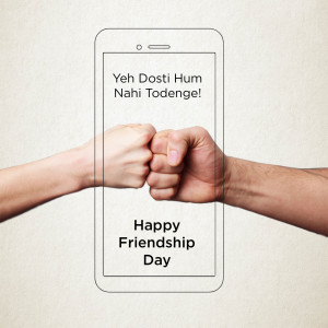Smartphone displaying a fist bump and 'Happy Friendship Day' text.