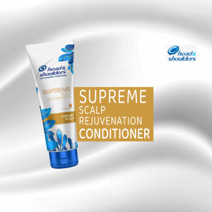 Close-up of Head & Shoulders Supreme Scalp Rejuvenation Conditioner tube on a silver background.