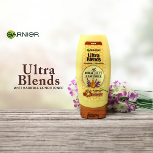 Garnier Ultra Blends Royal Jelly & Lavender Anti-Hairfall Conditioner bottle with floral background