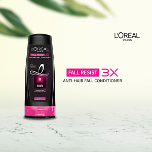 L'Oréal Paris Fall Resist 3X Anti-Hair Fall Conditioner bottle on a blurred background.