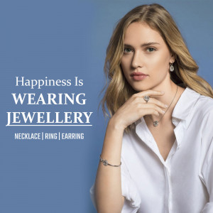 Woman wearing silver necklace, ring, and earrings