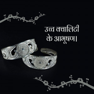 Close-up of two intricately designed silver anklets with blue stone embellishments.