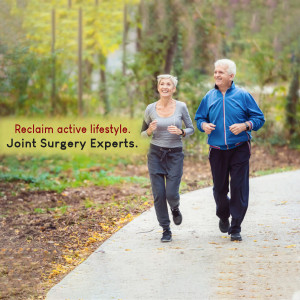 Elderly couple jogging outdoors, promoting joint surgery expertise.