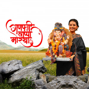 Woman holding a Ganesh idol with festive decorations