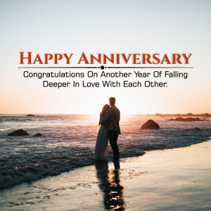 Couple embracing on a beach at sunset with 'Happy Anniversary' text overlay