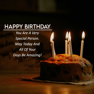 A birthday cake with lit candles and a 'Happy Birthday' message.