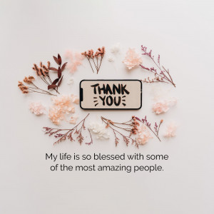Smartphone with 'Thank You' message surrounded by delicate flowers
