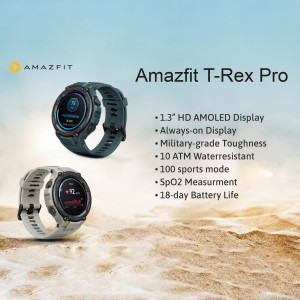 Amazfit T-Rex Pro smartwatch in grey and beige colors displayed on a sandy background