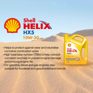 Shell Helix HX5 10W-30 motor oil bottle in a desert landscape