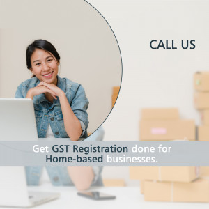 Woman working on laptop with boxes in the background and a call to action for GST registration.