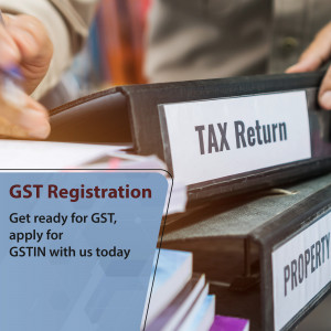 Close-up of hands holding folders labeled 'Tax Return' and 'GST Registration'.