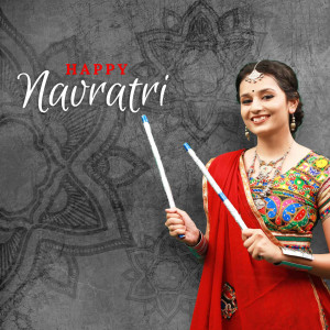Woman in traditional attire celebrating Navratri with Dandiya sticks